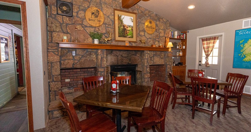 Interior, dining tables in front of a fireplace