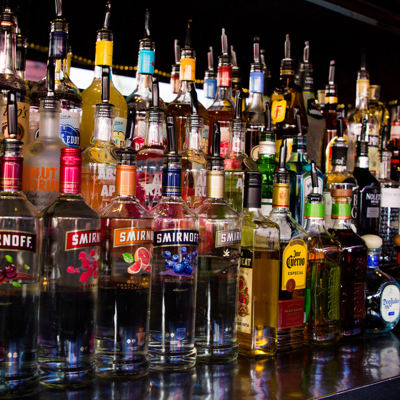A bar full of various liquor bottles