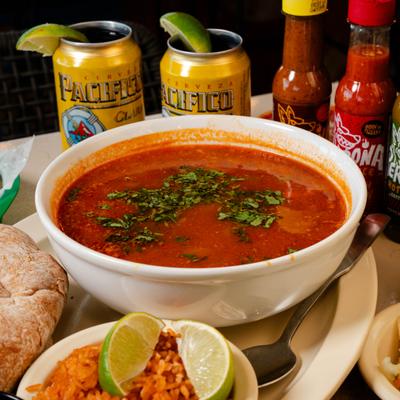 Shrimp souo served with sides of bread and rice.