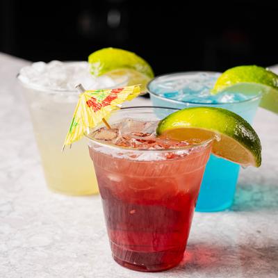 Assorted cocktails with citrus garnishes on the table.