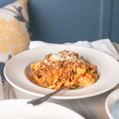 Pappardelle Integrale Alla Bianco Bolognese  “White” ragu' of ground beef, pork, mushroom, red wine, Cinnamon and Bechamel.
