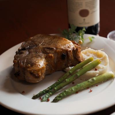 Veal chop served with asparagus and mashed potatoes.