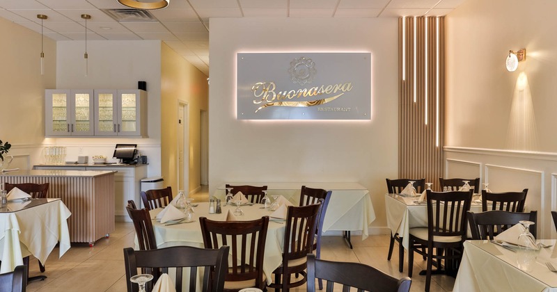 Interior, set tables and restaurant sign on the wall