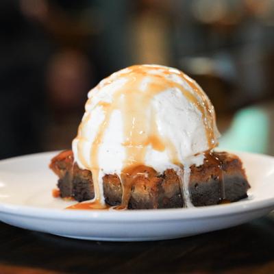 Brownie in the Rough topped with ice cream.