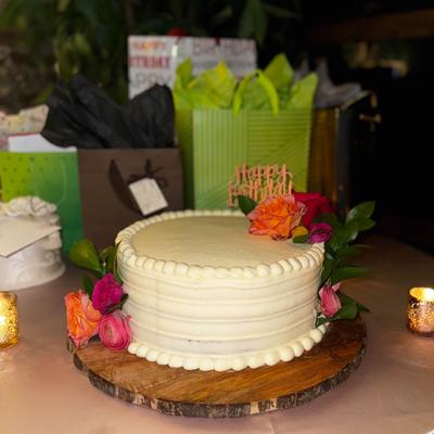 White cake decorated with colorful flowers.
