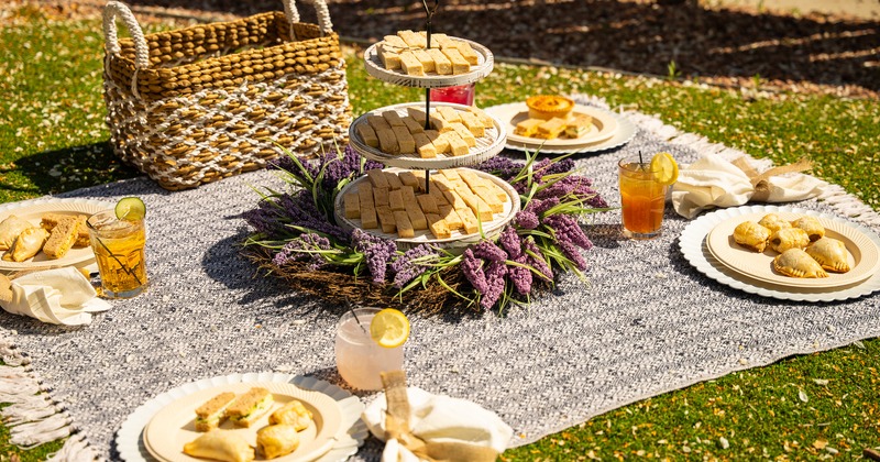 Interior, a table with assorted food trays, guests dining at tables in the background