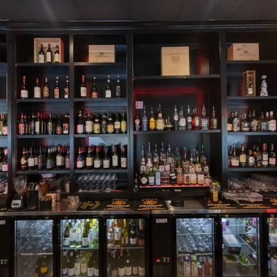 Various liquor bottles on the shelf.