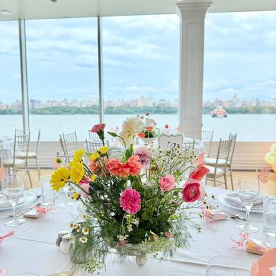 Colorful floral centerpiece on a round dining table.