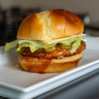 Spicy Deluxe Sandwich topped with pickles, lettuce and cheese.