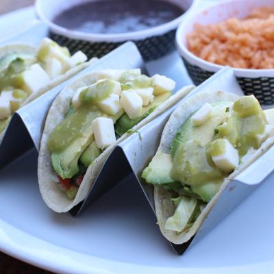Avocado Fresco Tacos served with rice and refried beans on the side.