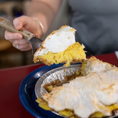 A hand serving up food.