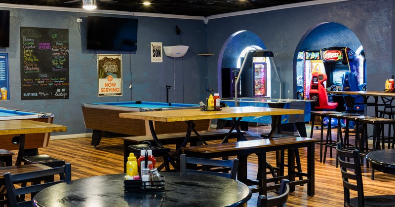 Interior with bar tables and stools, pool table
