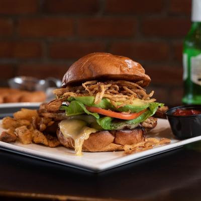 Grilled chicken sandwich with home fries.