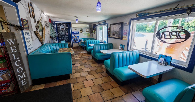 Interior, tables, chairs and light blue seating booths