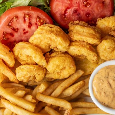 Fried shrimp, fries, and salad.