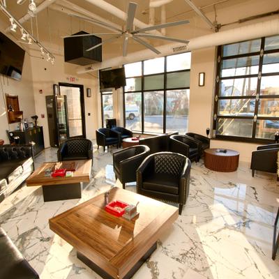 Interior with black leather seating and large windows.