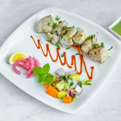 Boneless chicken, marinated in cream, with spices and a side salad.