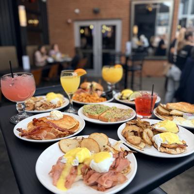 Assortment of dishes served on the table alongside cocktails.
