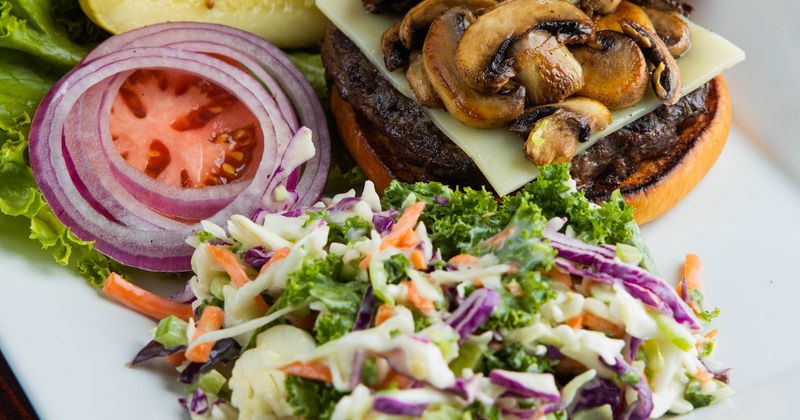 Burger served with fresh vegetables