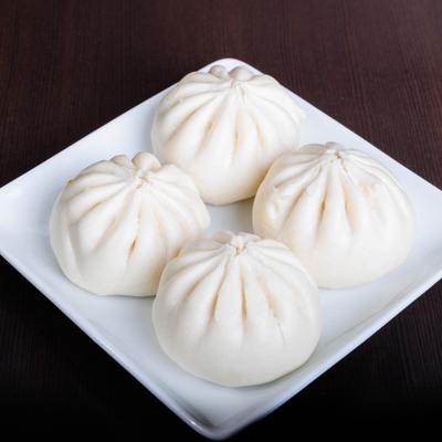 Pork buns on a white square plate.