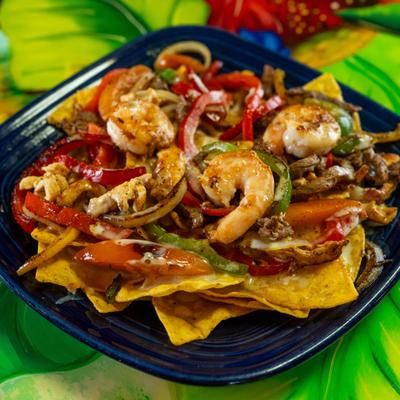 Fajita Nachos with beef, chicken, shrimp, peppers, and onions.