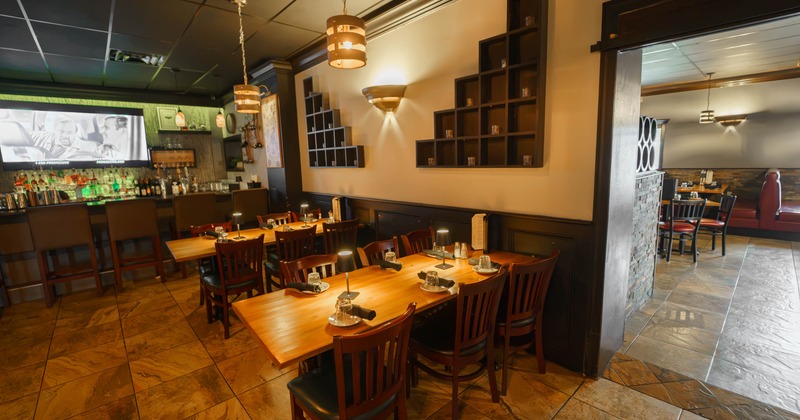 Interior, tables with chairs in front of the bar