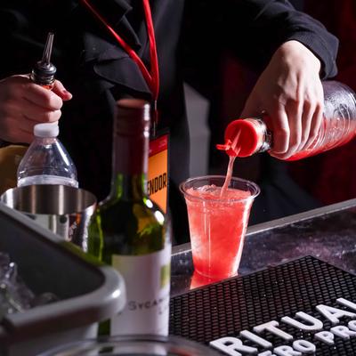 Bartender pouring a cocktail.