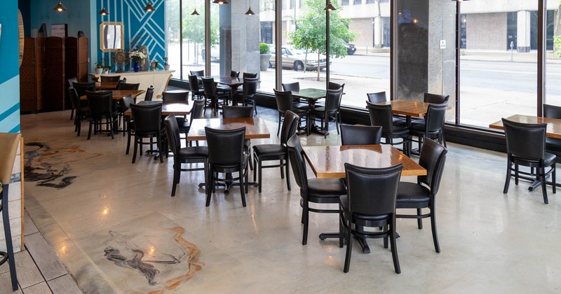 Interior, tables with chairs waiting for the guests