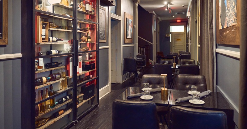 Interior, a row of dining tables, wine racks