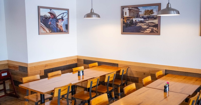 Interior, tables ready for guests, pictures on the wall