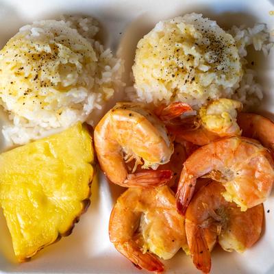 Lemon Pepper Shrimp served with rice and pineapple wedge.