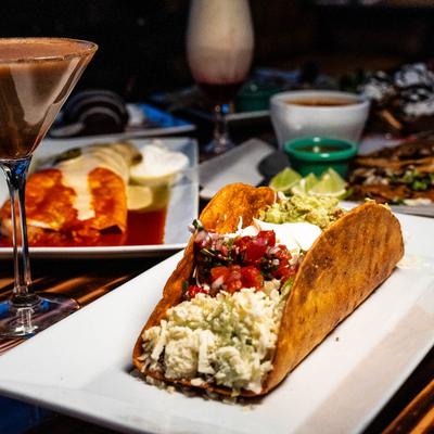 Various food dishes and cocktails placed on a table.