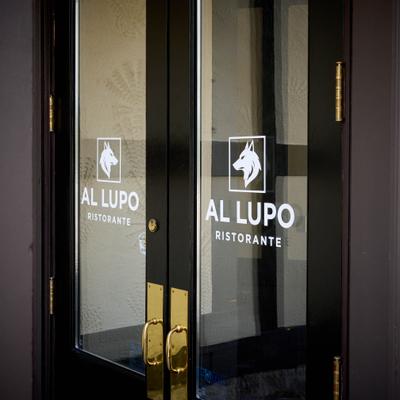 Restaurant front door with the logo printed on the glass.