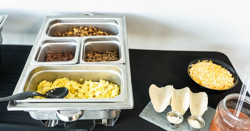 Various foods in serving containers, side view