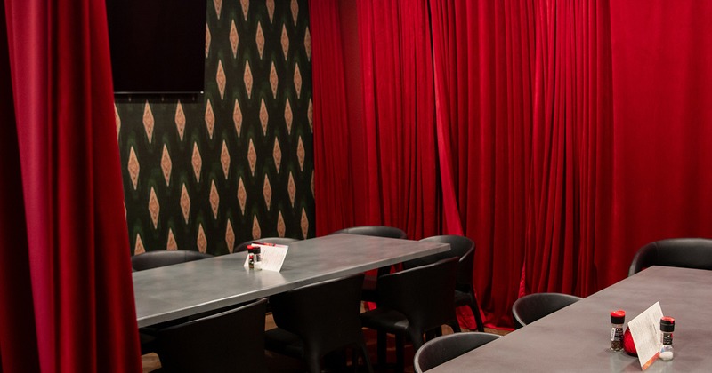 Dining area separated by red curtains