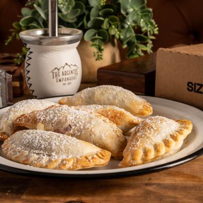 Dessert empanadas dusted with powdered sugar.