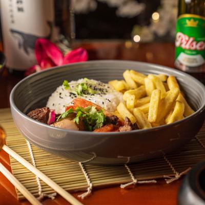 Stir fry steak with sides of rice abd fries.