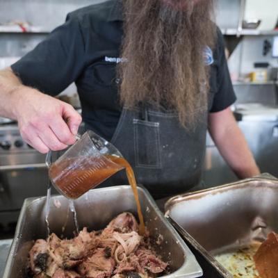 A staff member preparing food.