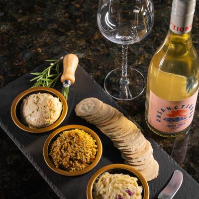 Crackers with spreads and a bottle of white wine.