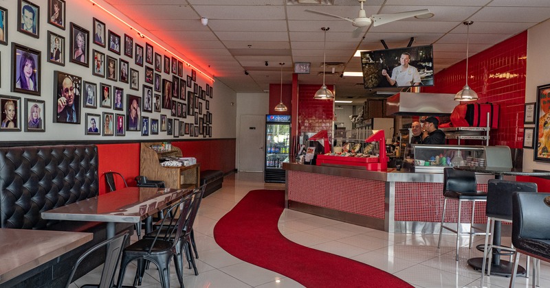 Interior of a modern casual pizza restaurant, seating area and order counter
