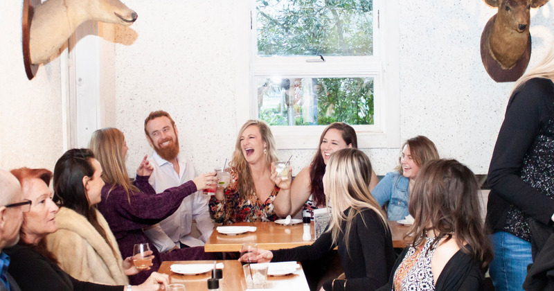 Interior, guests clicking the glasses and laughing