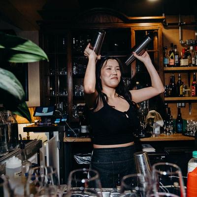 A bartender shaking cocktails.