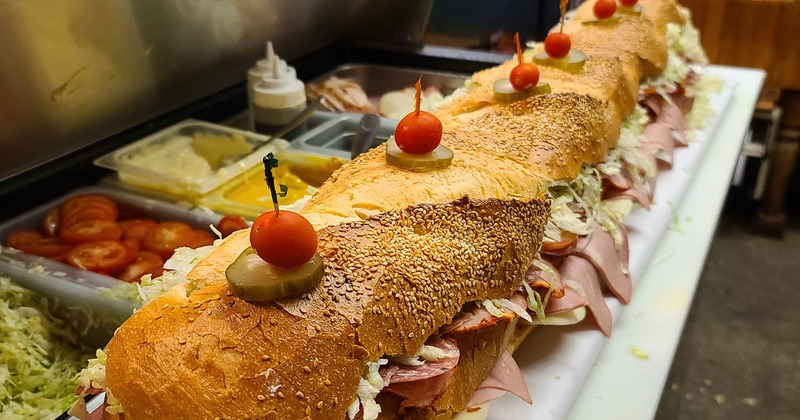 3-foot-long sandwich with deli meats, lettuce, and cheese