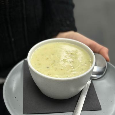 Hands carrying a drink on a platter.