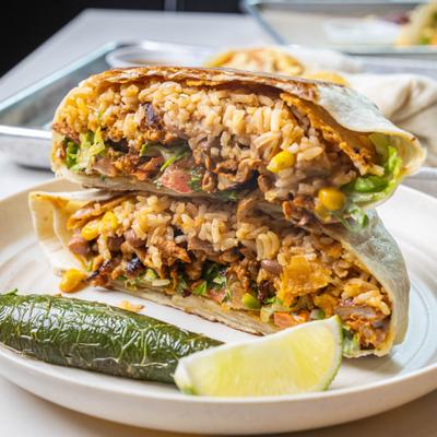 Crunch wrap cut open beside jalapeno and lime.