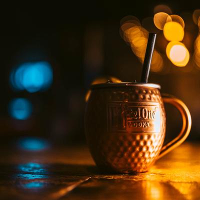 A drink served in a copper cup on a table.
