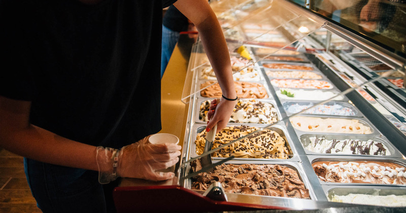 Employee scooping ice cream