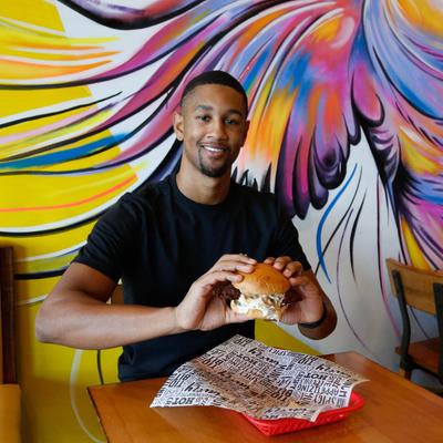 Customer having a chicken sandwich.