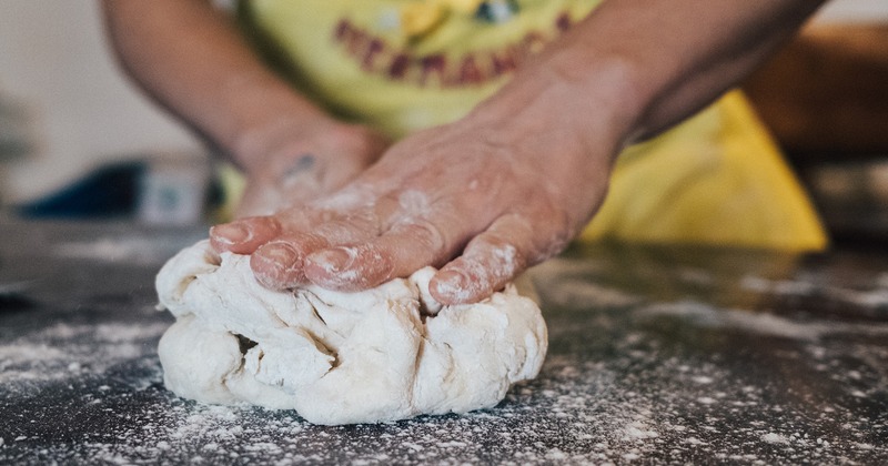 A person kneading dough