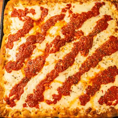 Square pizza topped with melted cheese and  tomato sauce.